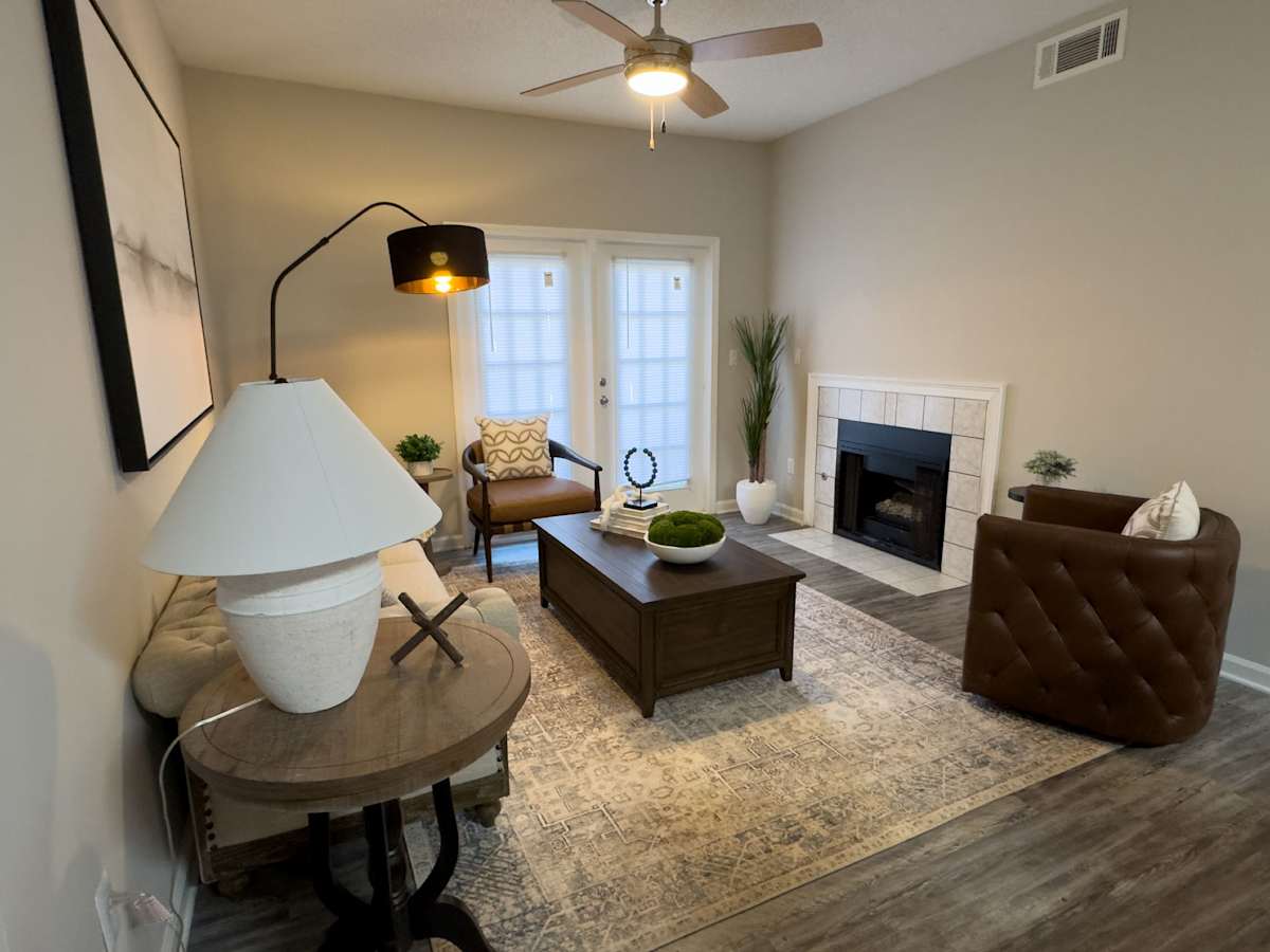 Model apartment: Enclave at Wolfchase living room with fireplace and ceiling fan - Memphis, TN