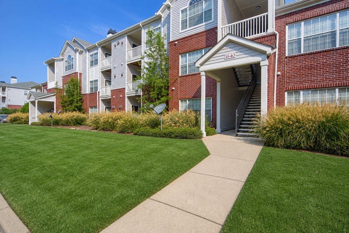 Enclave at Wolfchase exterior of apartment buildings with walkway - Memphis, TN