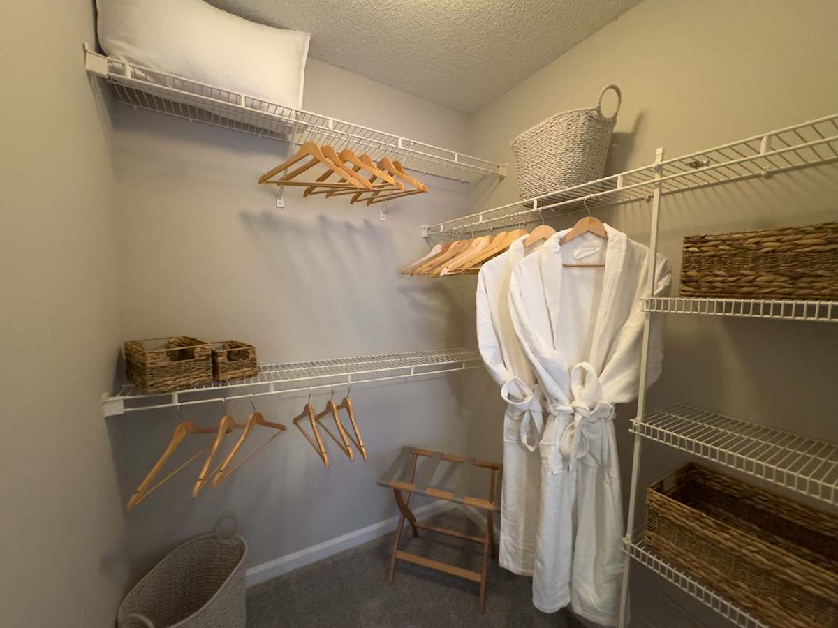 Model apartment: Enclave at Wolfchase walk-in closet with wire shelves and baskets - Memphis, TN