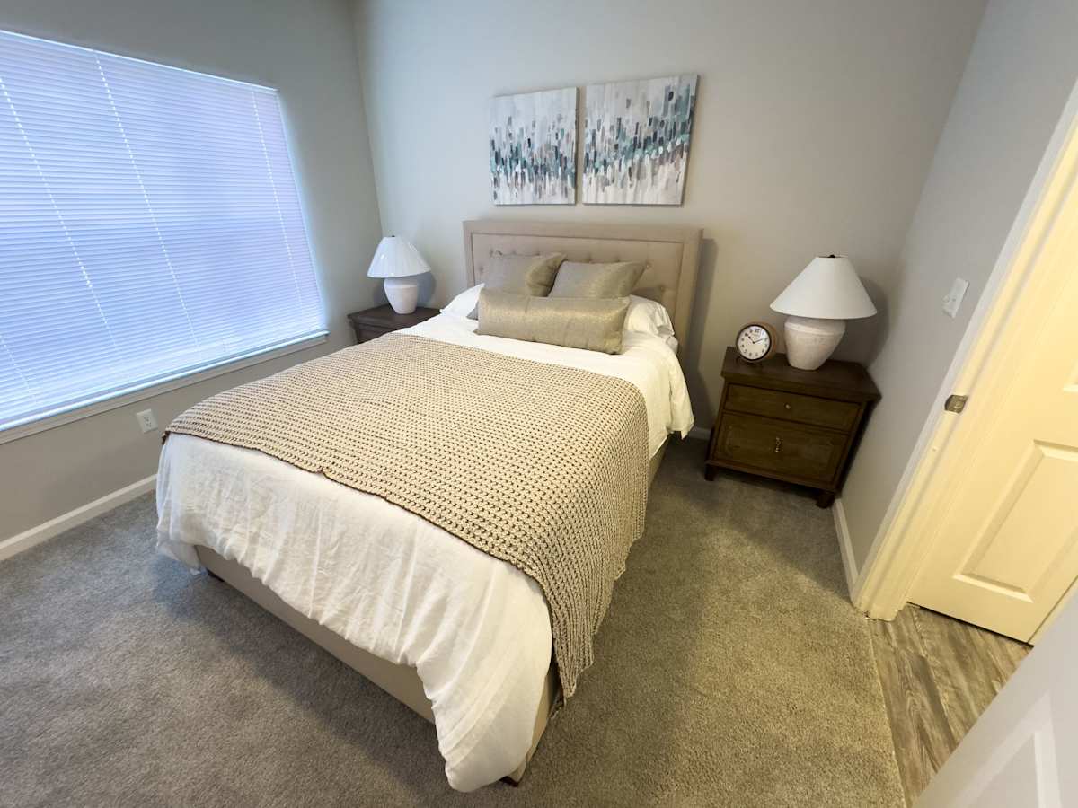 Model apartment: Enclave at Wolfchase bedroom with bed and nightstands - Memphis, TN